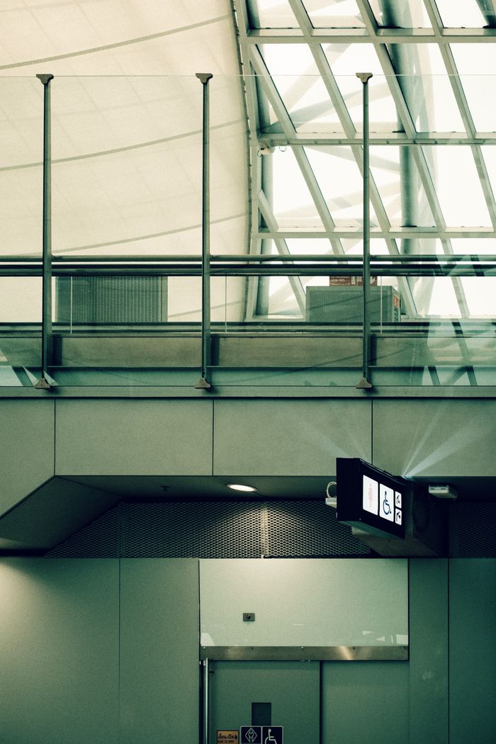 Interior view of a modern architectural space with glass and metal elements featuring geometric design.